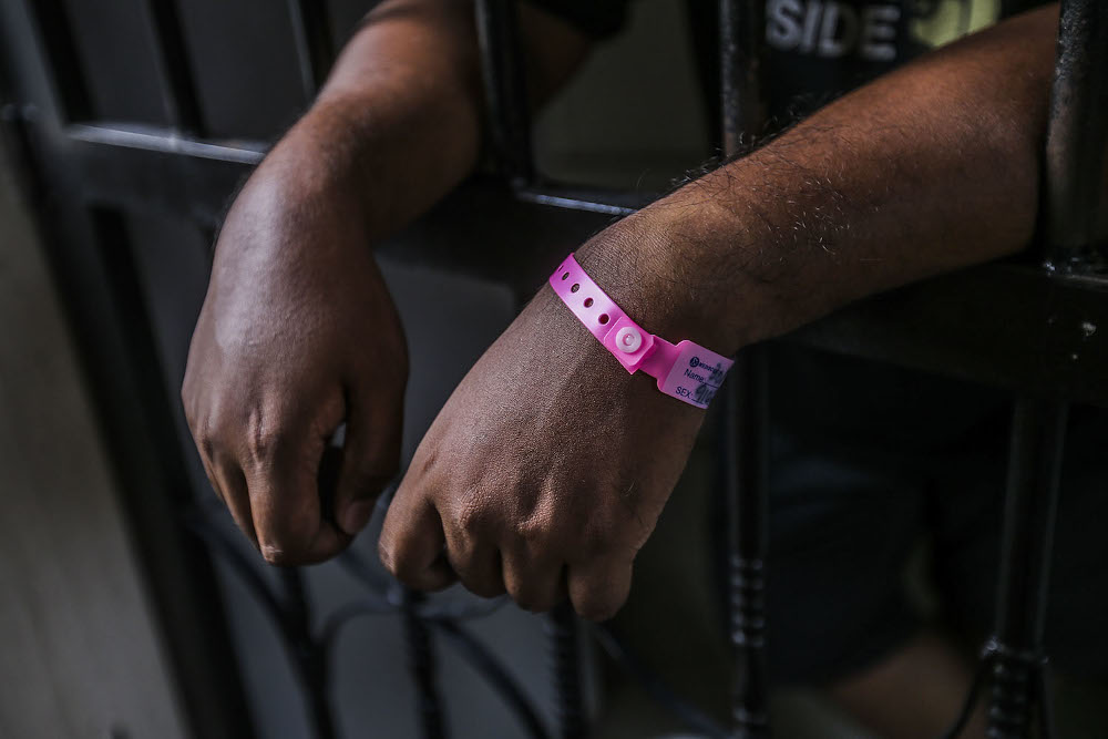 A man is seen standing at his house gate after being ordered to undergo home quarantine in Kuala Lumpur October 4, 2020. u00e2u20acu201d Picture by Hari Anggara.