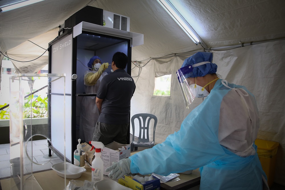 A health worker inside a protective chamber collects swab samples to test for Covid-19 at the Sunway Medical Centre in Subang Jaya October 15, 2020. u00e2u20acu201d Picture by Yusof Mat Isa