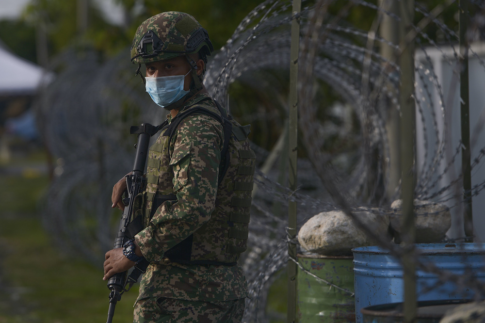 A personnel from the Armed Forces on duty at Taman Langat Murni in Banting after it was put under the enhanced movement control order (EMCO), October 29, 2020. u00e2u20acu201d Picture by Miera Zulyana