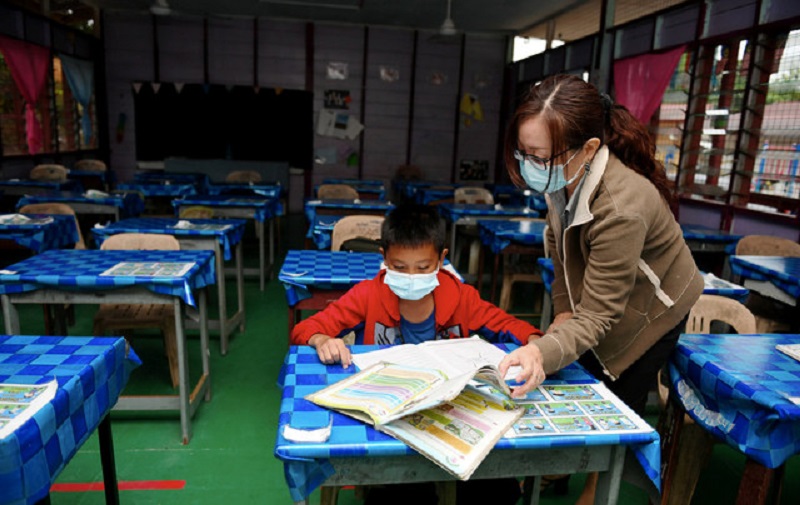 A standard five student is seen in class with his teacher at Sekolah Kebangsaan Buit Hill Penampang in Kota Kinabalu October 5, 2020. u00e2u20acu201d Bernama pic