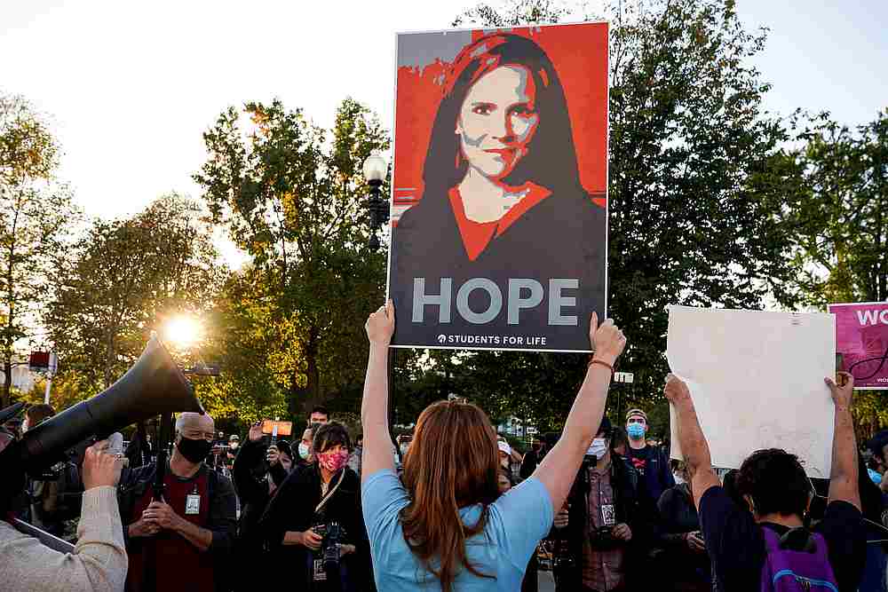 An activist supporting the nomination of Amy Coney Barrett to the Supreme Court holds up a sign at the Supreme Court in Washington October 26, 2020. u00e2u20acu201d Reuters pic