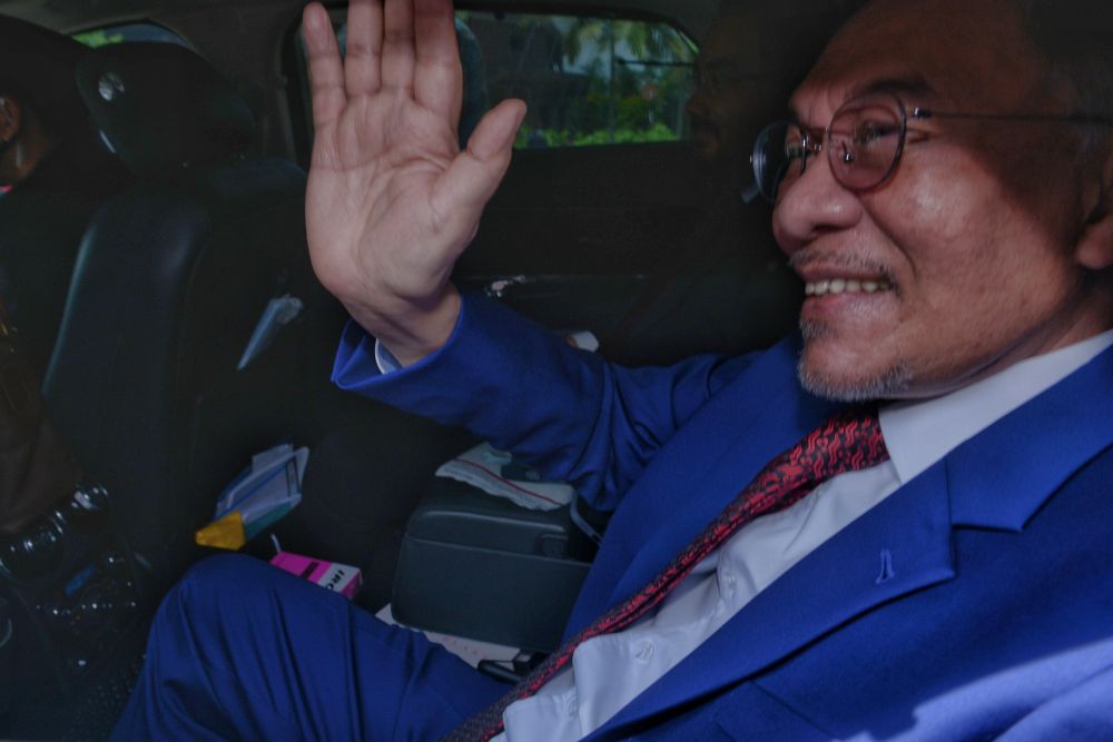 Datuk Seri Anwar Ibrahim waves at reporters as he leaves Istana Negera, Kuala Lumpur October 13, 2020. u00e2u20acu201d Picture by Ahmad Zamzahuri