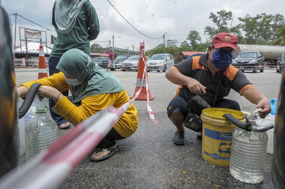 Residents fill their pails at a water point in Bangi following the water disruption in Hulu Selangor October 6, 2020. u00e2u20acu2022 Picture by Shafwan Zaidon