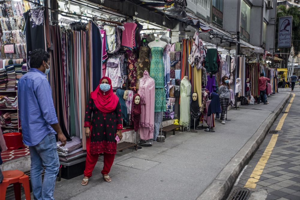 Street vendors are seen waiting for customers in front of their shops on Jalan Tuanku Abdul Rahman amid the conditional movement control order in Kuala Lumpur October 23, 2020. u00e2u20acu201d Picture by Firdaus Latif
