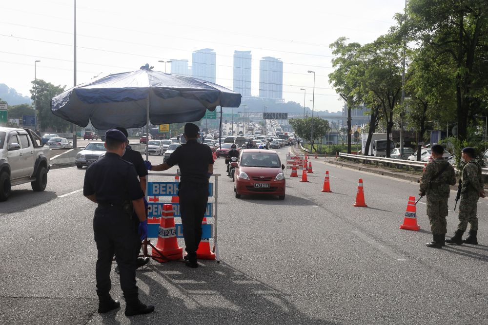 Police and Armed Forces personnel man a roadblock on the Damansara-Puchong Highway in Puchong October 14, 2020. u00e2u20acu201d Picture by Choo Choy May