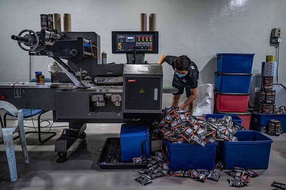 A worker sorting coffee packets at the Antong Coffee Factory in Taiping, Perak September 29, 2020. u00e2u20acu201d AFP pic