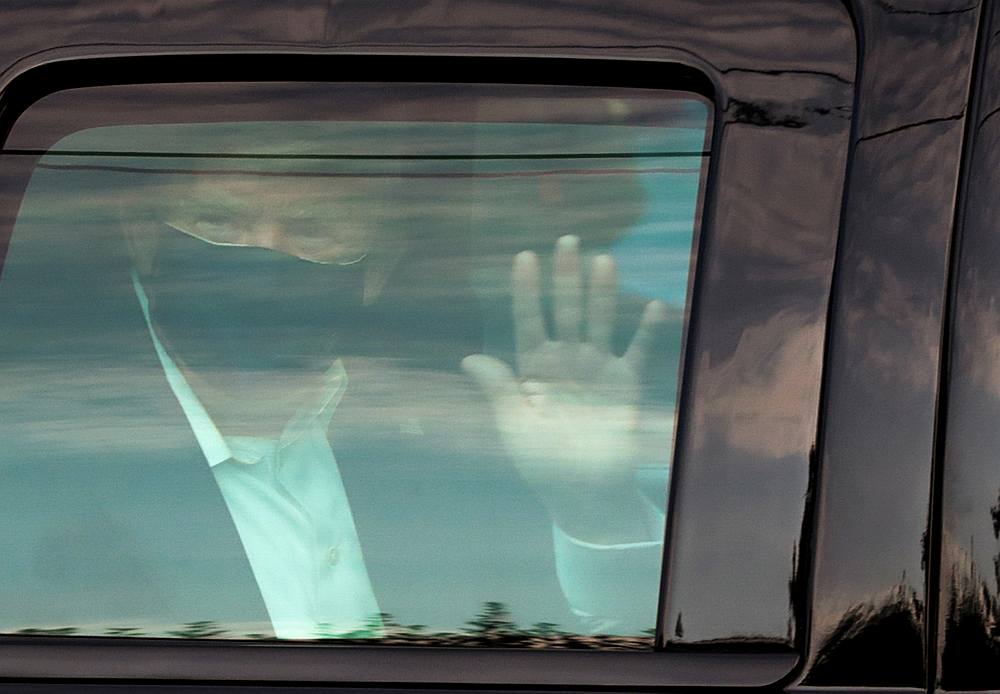US President Donald Trump waves to supporters as he briefly rides by in the presidential motorcade in front of Walter Reed National Military Medical Center in Bethesda, Maryland October 4, 2020. u00e2u20acu201d Reuters pic