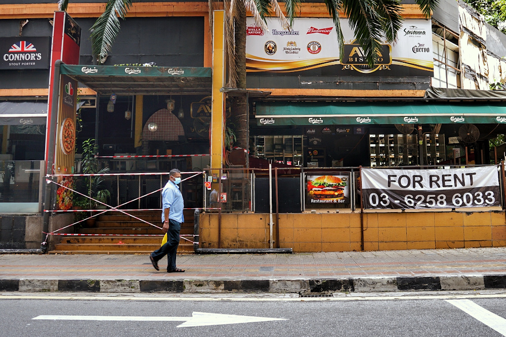 A man walks past a shuttered bar/night club with a u00e2u20acu02dcFor Rentu00e2u20acu2122 sign in Kuala Lumpur during the Covid 19 pandemic October 18, 2020. u00e2u20acu201d Picture by Ahmad Zamzahuri