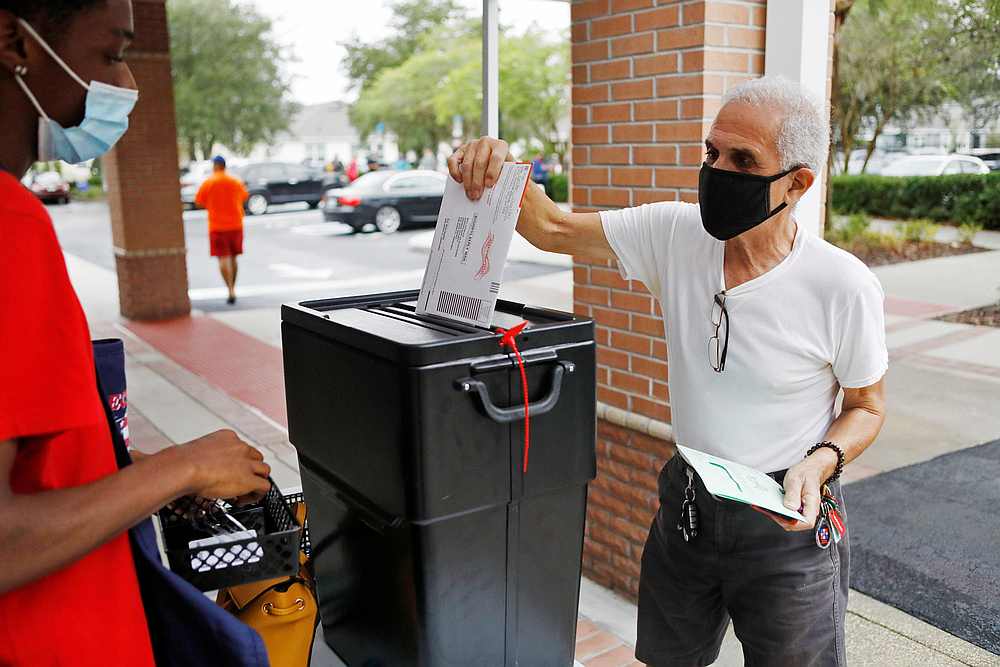 Florida resident Valentine Lugo casts his mail-in ballot at the Winter Garden Library polling station as early voting begins ahead of the election in Orlando, Florida October 19, 2020. u00e2u20acu201d Reuters pic