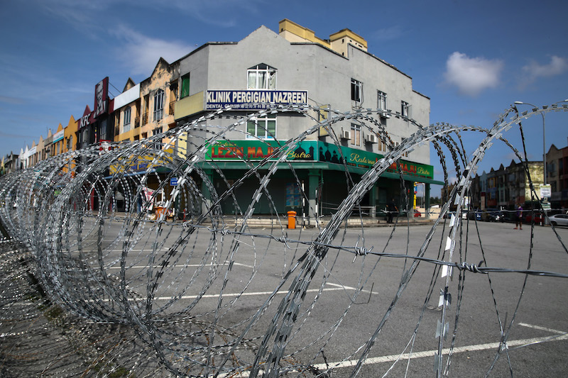 A shopkeeper waits for customers at his grocery store in Medan 88, Bandar Baru Salak Tinggi in Sepang during the enhanced movement control order November 15, 2020. u00e2u20acu201d Picture by Yusof Mat Isa