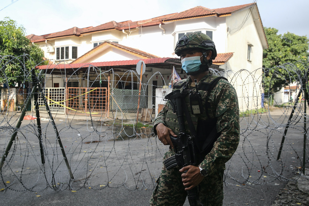 An Armed Forces personnel stands guard in the vicinity of Top Glove Corporation Berhad's staff dormitories during the enhanced movement control order (EMCO) in Klang November 17, 2020. u00e2u20acu201d Picture by Yusof Mat Isa