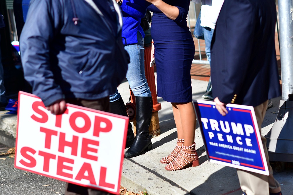 Trump supporters carry a u00e2u20acu02dcStop The Stealu00e2u20acu2122 and campaign sign after Democratic presidential nominee Joe Biden overtook President Donald Trump in the Pennsylvania general election vote count in Philadelphia November 6, 2020. u00e2u20acu201d Reuters pic