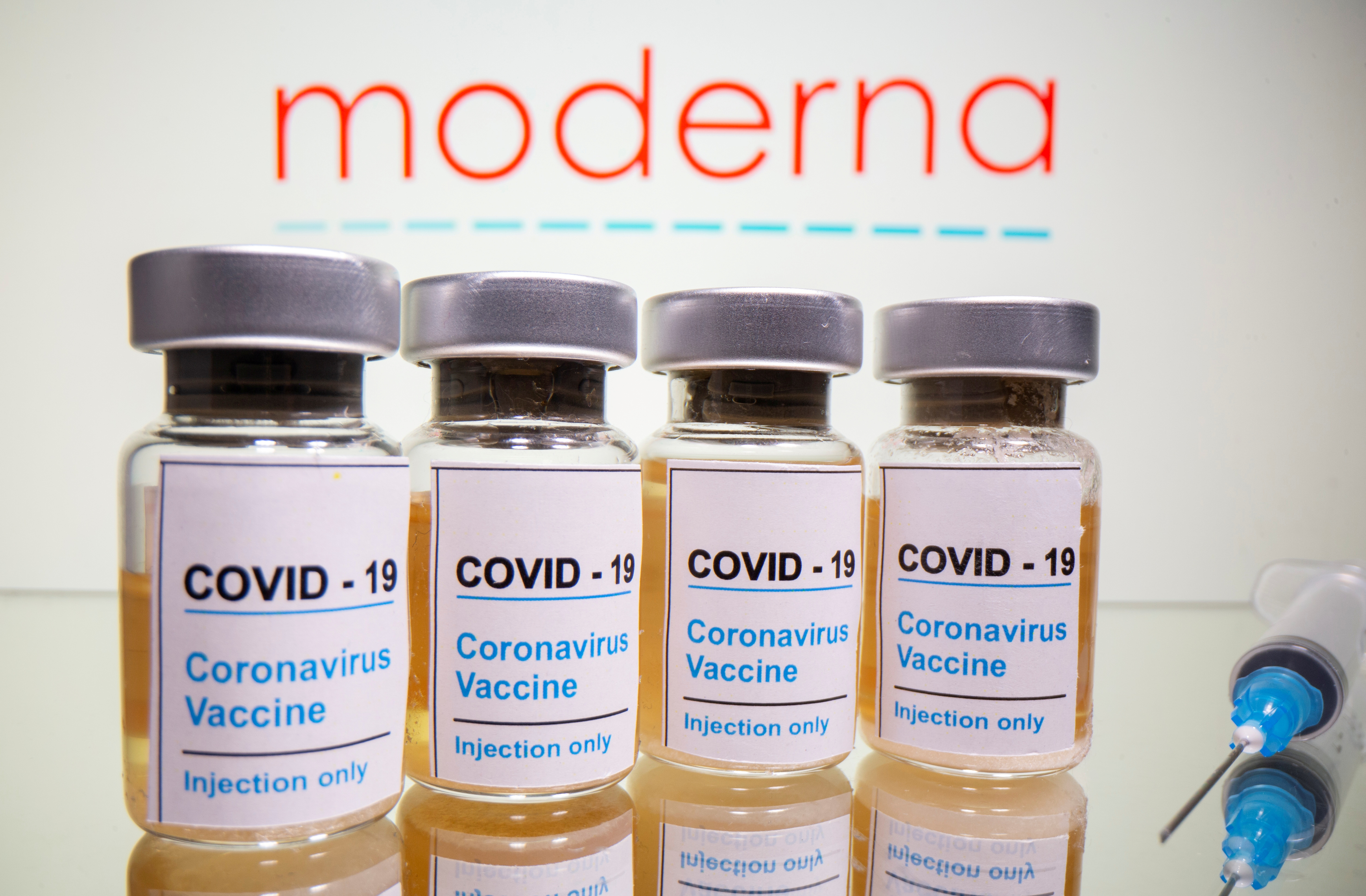 Vials with a sticker reading, u00e2u20acu02dcCOVID-19 / Coronavirus vaccine / Injection onlyu00e2u20acu2122 and a medical syringe are seen in front of a displayed Moderna logo in this illustration taken October 31, 2020. u00e2u20acu201d Reuters pic
