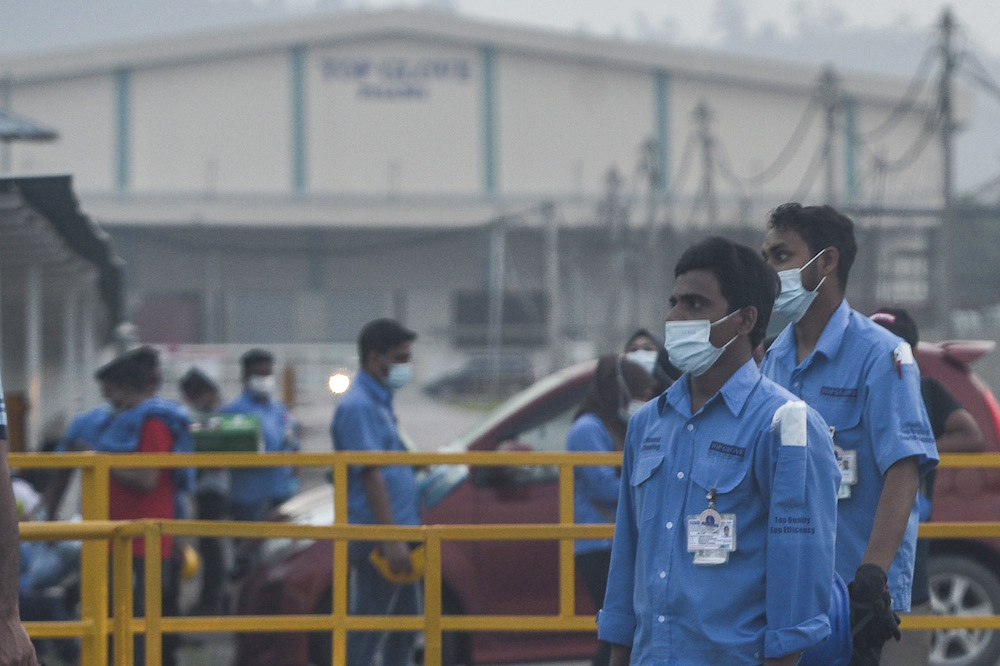 Workers are pictured outside a Top Glove factory in Klang November 26, 2020. u00e2u20acu201d Picture by Miera Zulyana 