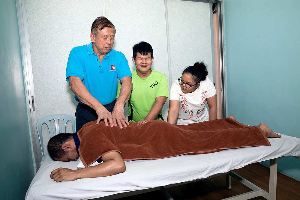 Former Paralympian Lee Seng Chow (standing left) now operates a massage centre in Brickfields and employs 33 masseurs. u00e2u20acu201d Photo via Facebook/ PB Blind Massage