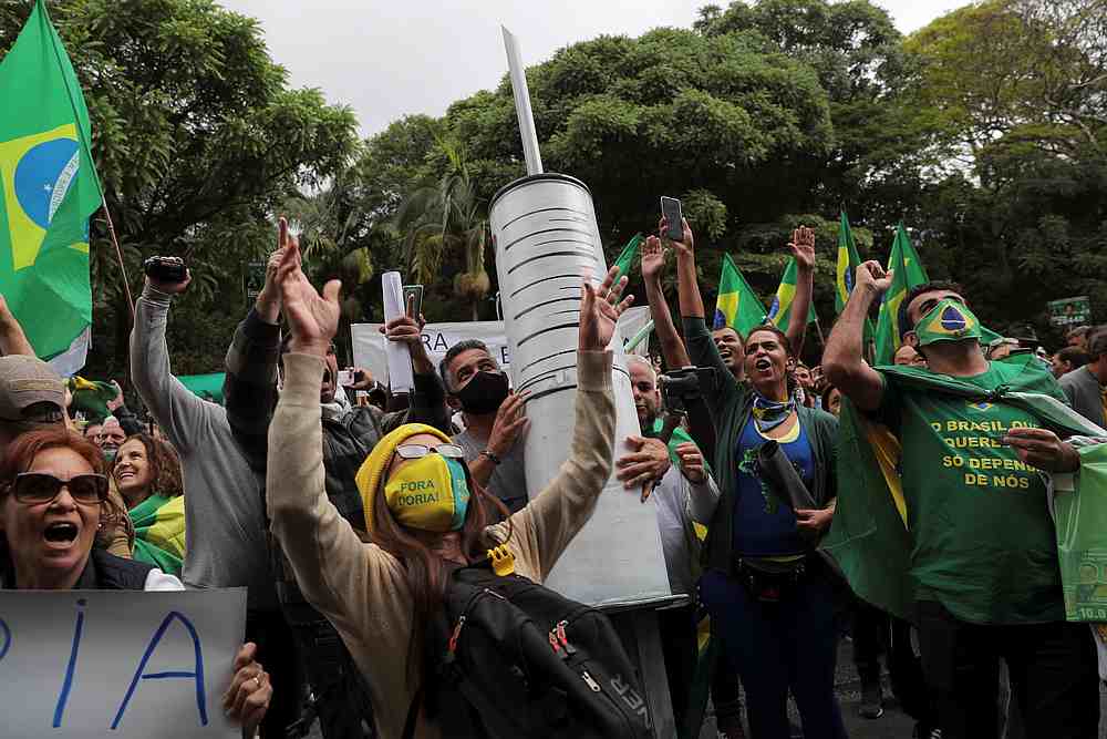 Demonstrators carry a giant syringe as they protest against Sao Paulo state governor Joao Doria and China's Sinovac potential Covid-19 vaccine in Sao Paulo, Brazil November 1, 2020. u00e2u20acu201d Reuters pic