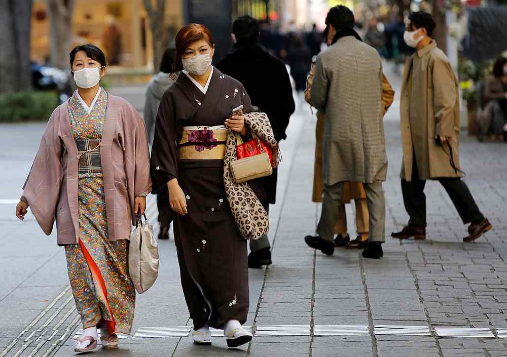 Women wearing kimono and protective masks, following the Covid-19 outbreak, walk in Tokyo, Japan November 13, 2020. u00e2u20acu201d Reuters pic