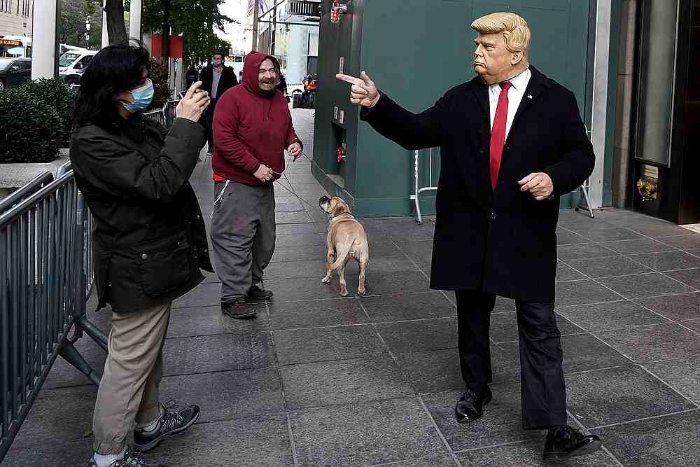 A man dressed as US President Donald Trump imitates him as he walks around Trump Tower on Election Day in the Manhattan borough of New York November 3, 2020. u00e2u20acu201d Reuters pic
