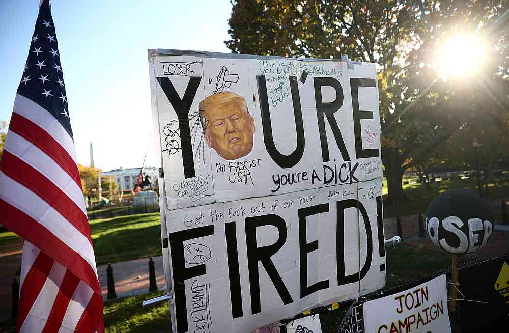 A 'You're Fired' sign with the image of US President Donald Trump hangs atop a fence in front of the White House in Washington November 9, 2020. u00e2u20acu201d Reuters pic