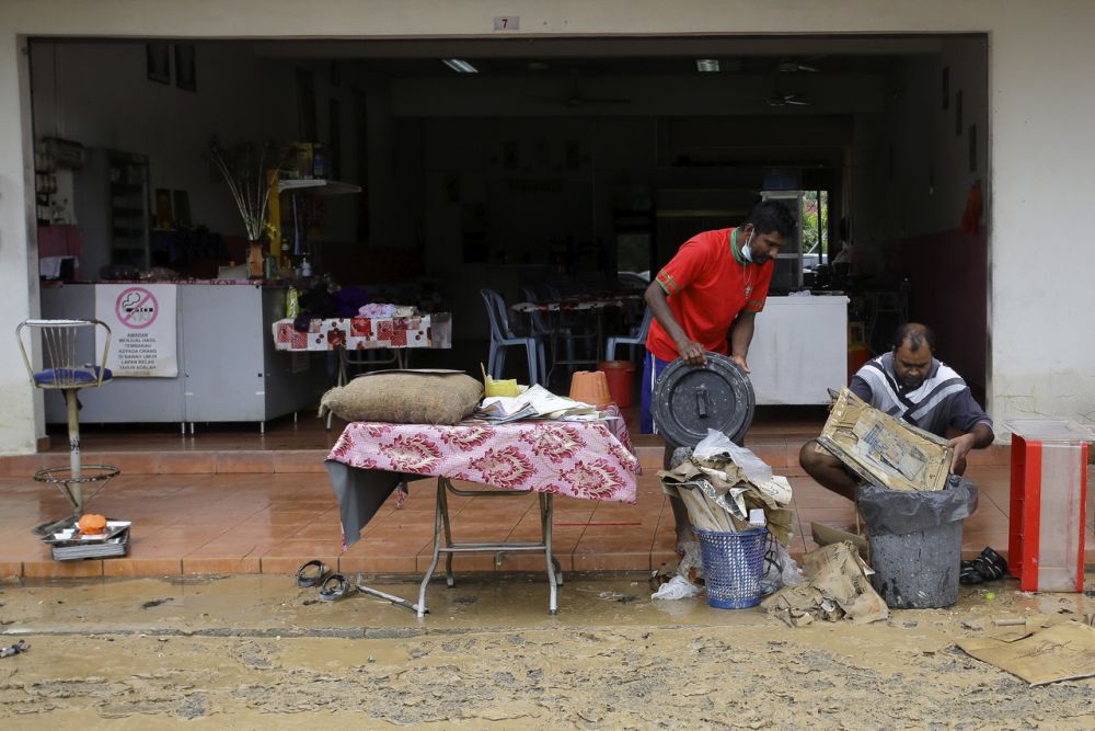 Restaurant workers are seen salvaging items after Seremban was hit by flash floods earlier today. u00e2u20acu201d Bernama pic