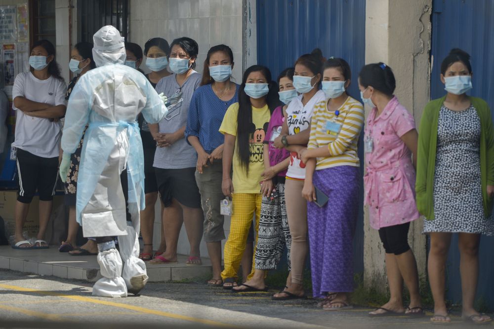 Foreign workers wait to get tested for Covid-19 at Top Gloveu00e2u20acu2122s female staff dormitory in Klang November 18, 2020. u00e2u20acu201d Picture by MIera Zulyana