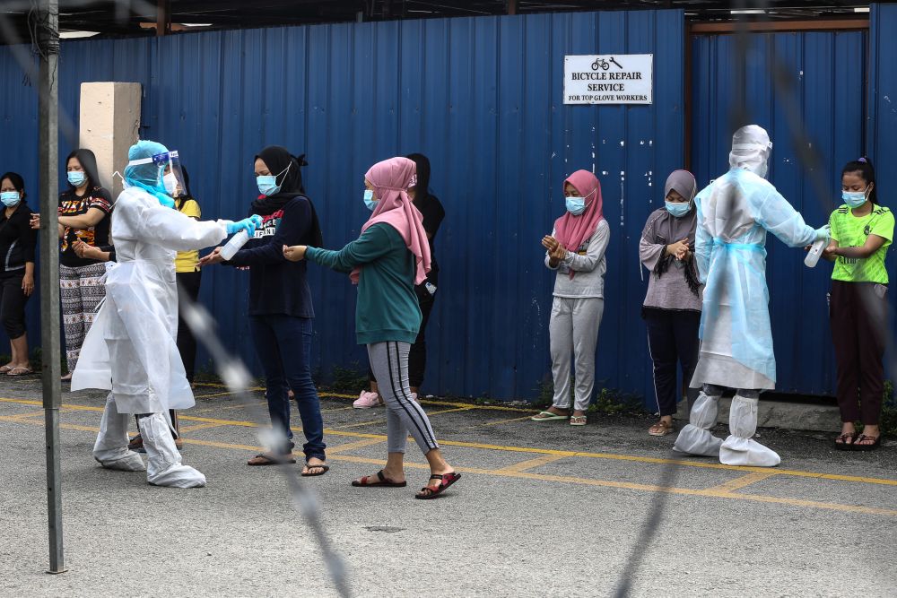 Foreign workers wait to get tested for Covid-19 at Top Gloveu00e2u20acu2122s female staff dormitory in Klang November 18, 2020. u00e2u20acu201d Picture by Yusof Mat Isa