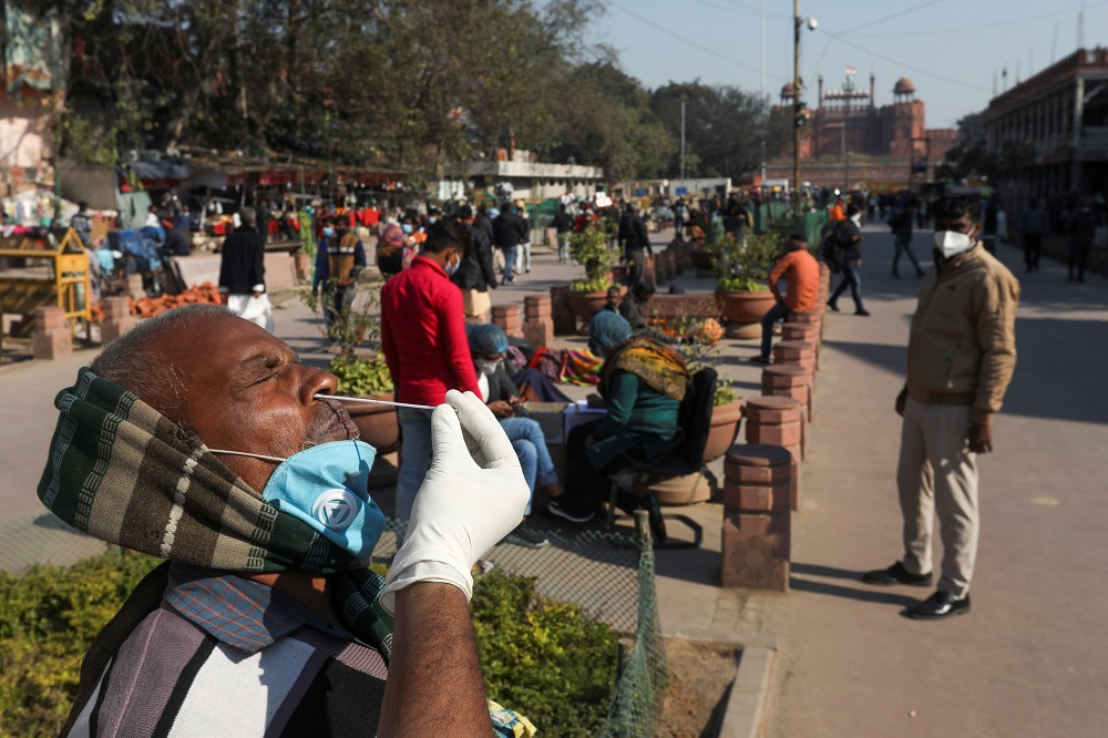 A healthcare worker collects a swab sample from a man, amidst the spread of the coronavirus disease, at Chandni Chowk, in the old quarters of Delhi December 18, 2020. u00e2u20acu201d Reuters pic