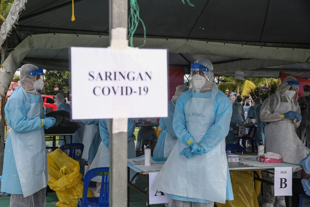 Health workers wearing protective suits are pictured during a community screening operation to test residents for Covid-19 at the Dewan Masyarakat Taman Meru 3 in Klang December 2, 2020. u00e2u20acu201d Picture by Yusof Mat Isa