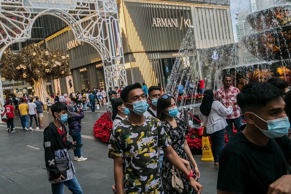 People are seen wearing protective masks as they walk outside Pavillion Kuala Lumpur December 6, 2020. u00e2u20acu2022 Picture by Firdaus Latifnn