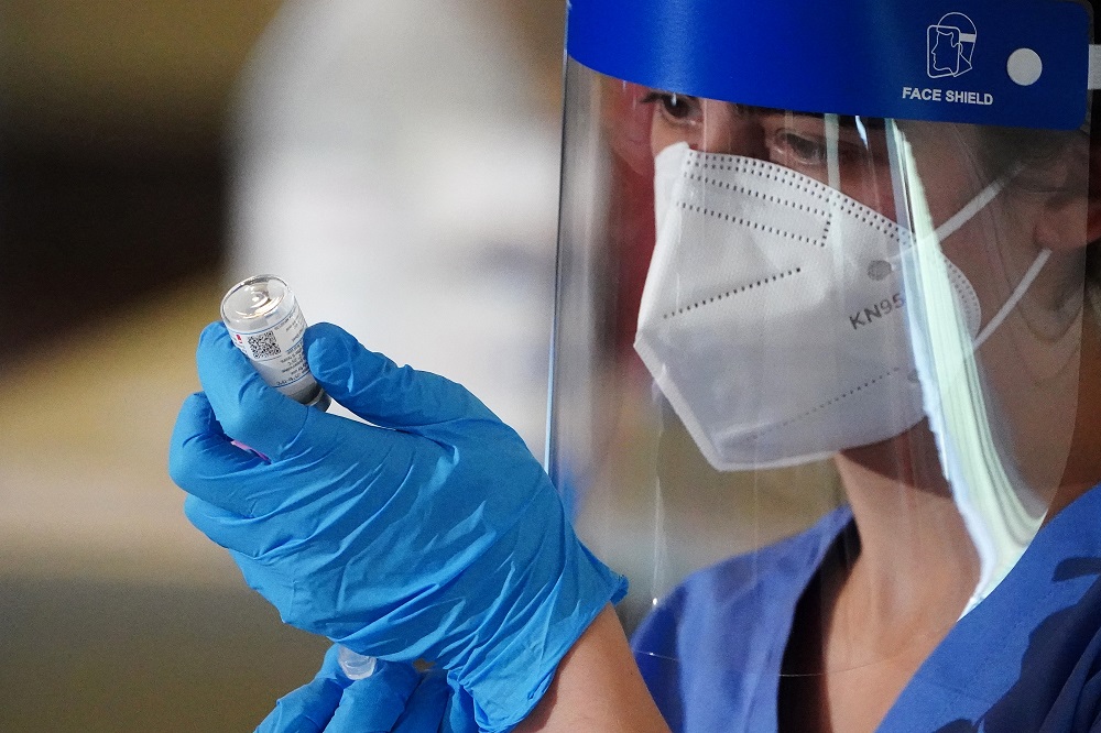 A nurse prepares a syringe with the Covid-19 Moderna vaccine for a worker of the New York City Fire Department Bureau of Emergency Medical Services (FDNY EMS) in the Manhattan borough of New York City, New York December 23, 2020. u00e2u20acu2022 Reuters picn