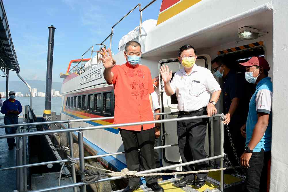 Penang Chief Minister Chow Kon Yeow (right) and Penang Port Commission chairman Datuk Tan Teik Cheng (left) boarding the new speedboat ferry at Swettenham Pier December 30, 2020. u00e2u20acu201d Picture courtesy of Penang Chief Minister's Office