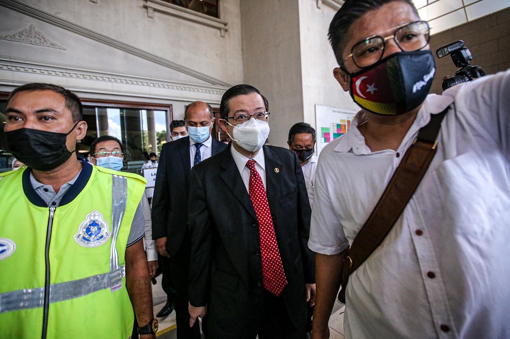 Lim Guan Eng (centre) is seen leaving the Kuala Lumpur High Court December 21, 2020. u00e2u20acu201d Picture by Hari Anggara