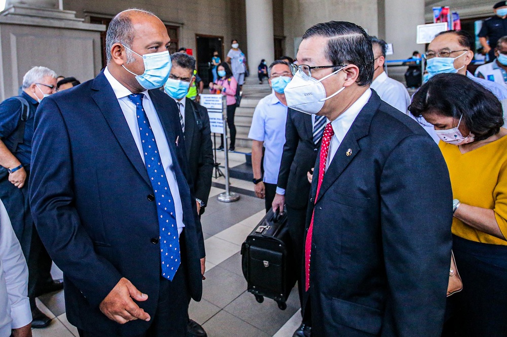 Lim Guan Eng (right) is seen with his lawyer Gobind Singh Deo outside the Kuala Lumpur High Court December 21, 2020. u00e2u20acu201d Picture by Hari Anggara