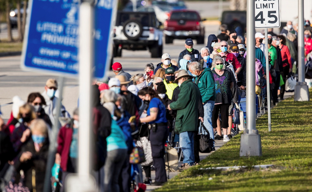 Hundreds wait in line at Lakes Park Regional Library to receive the Covid-19 vaccine in Fort Myers, Florida December 30, 2020. u00e2u20acu201d Andrew West/The News-Press/USA Today Network via Reuters