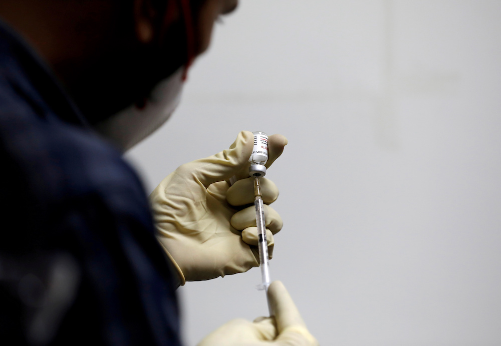 A medic fills a syringe with Covaxin before administering it to a health worker during its trials, at the Gujarat Medical Education and Research Society in Ahmedabad, India, November 26, 2020. u00e2u20acu201d Reuters pic 