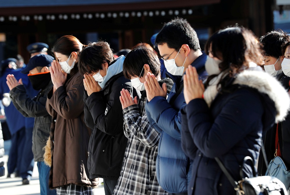 People wearing protective masks amid the coronavirus disease outbreak, pray on the first day of the new year at the Meiji Shrine in Tokyo 2021. u00e2u20acu201d Reuters picn