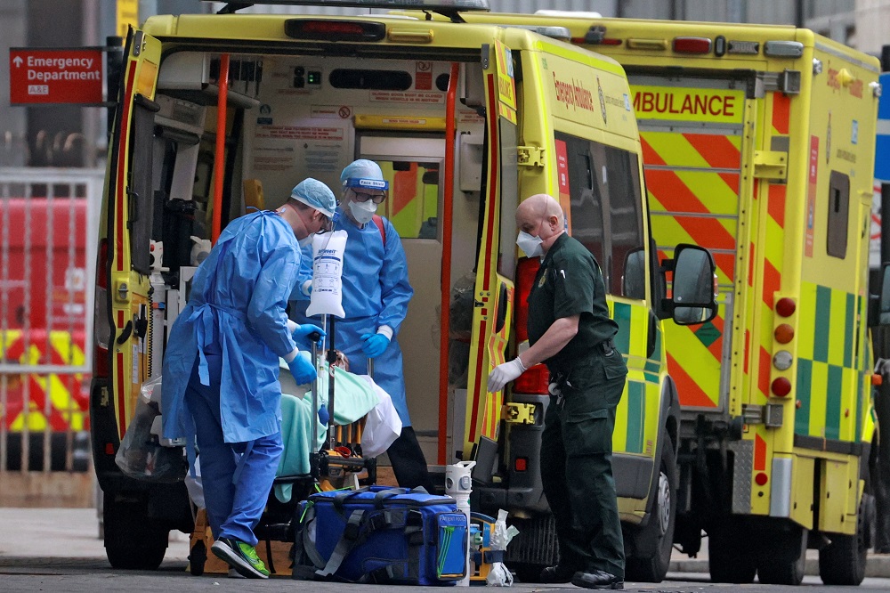 Medics transport a patient from an ambulance to the Royal London Hospital as the spread of the coronavirus disease continues in London January 1, 2021. u00e2u20acu201d Reuters pic