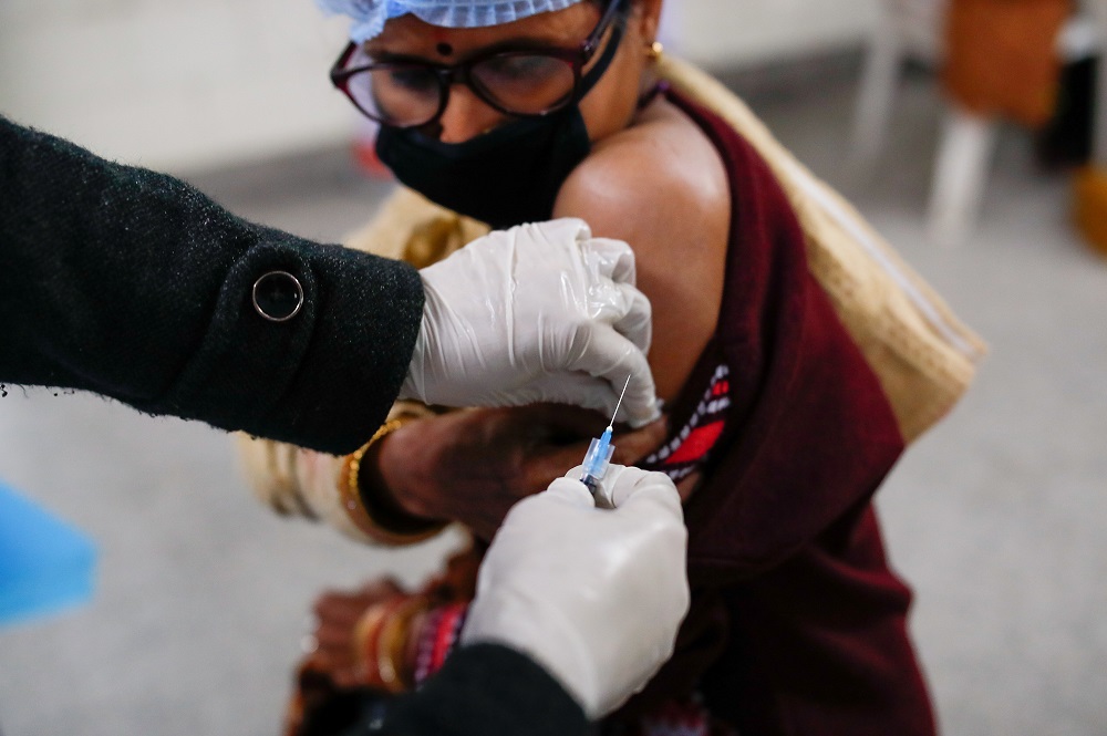 A health worker and a volunteer take part in a nationwide trial run of coronavirus disease vaccine delivery systems, inside a school, which has been converted into a temporary vaccination centre, in New Delhi January 8, 2021. u00e2u20acu201d Reuters pic