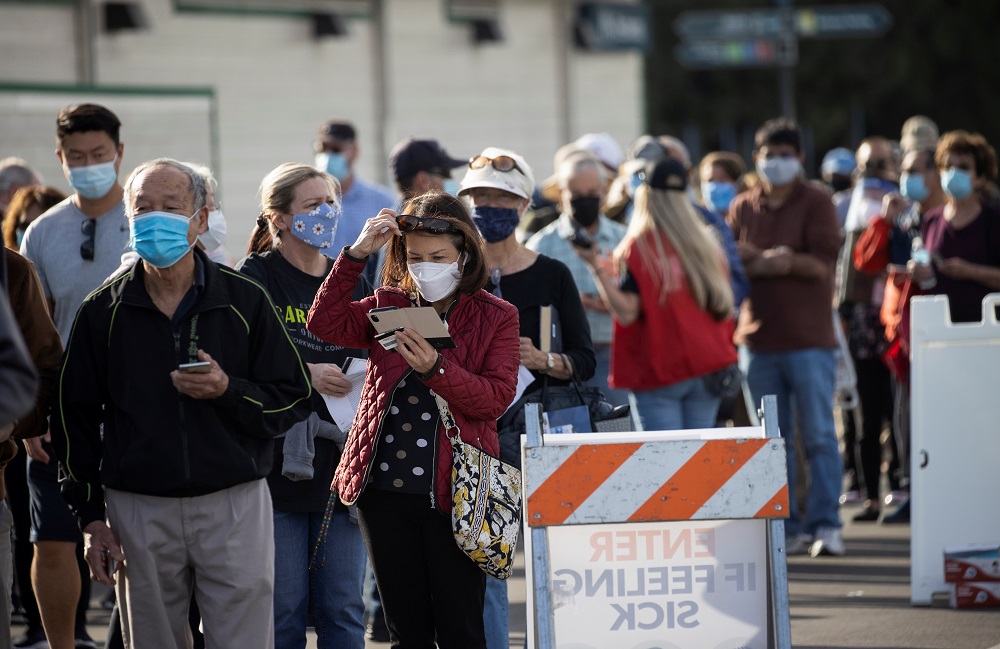 People wait in line in a Disneyland parking lot to receive a dose of the Moderna Covid-19 at a mass vaccination site in Anaheim January 13, 2021. u00e2u20acu201d Reuters pic