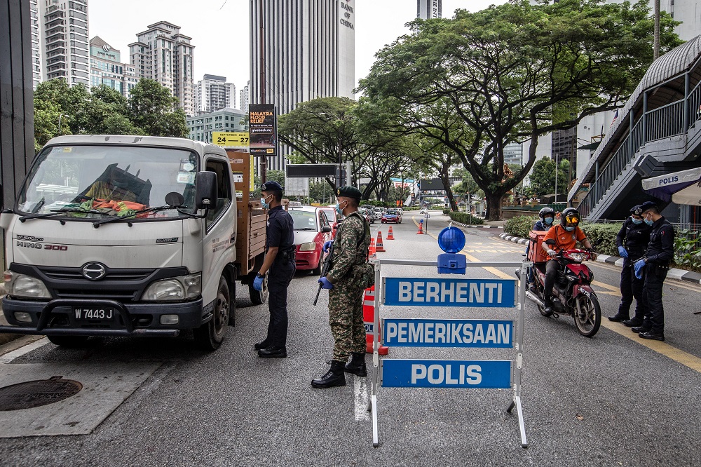 Soldiers and police officers conducting checks at a roadblock near Bukit Bintang in Kuala Lumpur January 13, 2021. u00e2u20acu201d Picture by Firdaus Latif