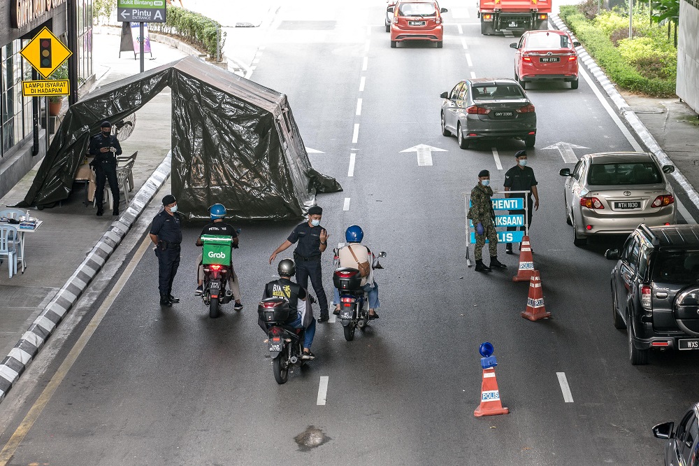 Soldiers and police officers conducting checks at a roadblock near Bukit Bintang in Kuala Lumpur January 13, 2021. u00e2u20acu201d Picture by Firdaus Latif