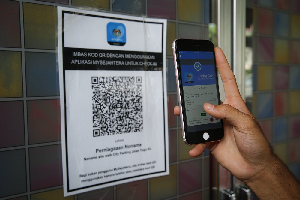 A user scans a QR code via the My Sejahtera app at a restaurant in Kuala Lumpur January 16, 2020. u00e2u20acu201d Picture by Yusof Mat Isa