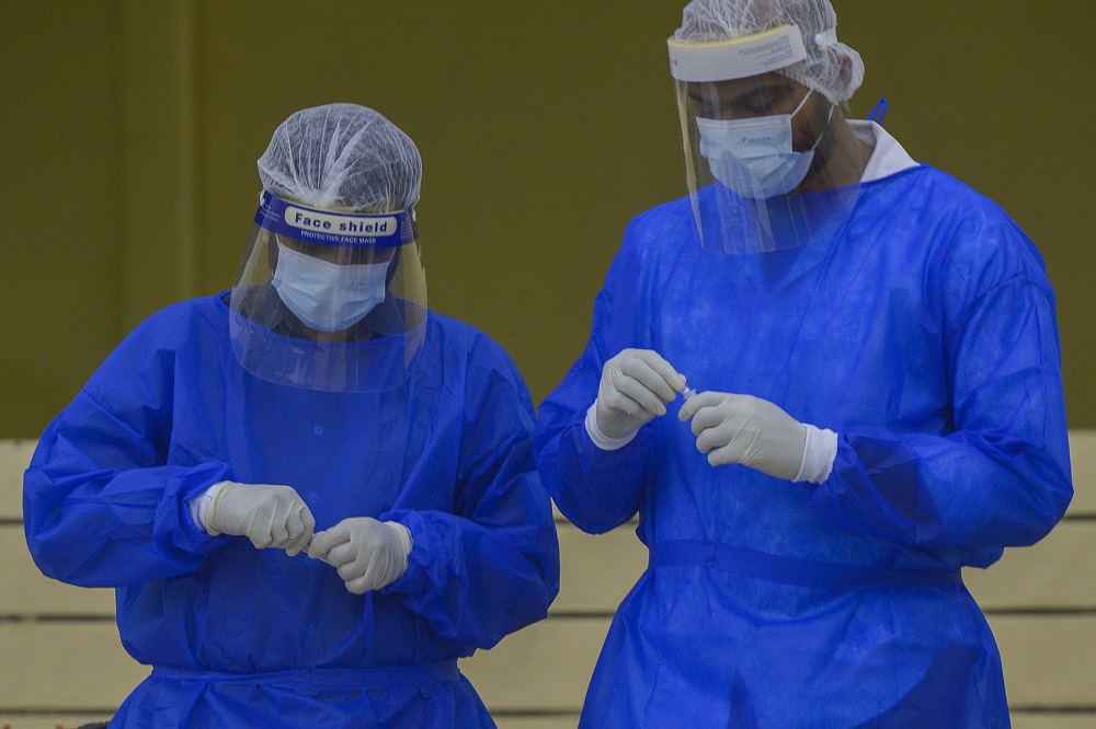 Health workers in protective suits collect swab samples to test for Covid-19 in Petaling Jaya January 18, 2021. u00e2u20acu201d  Picture by Miera Zulyana