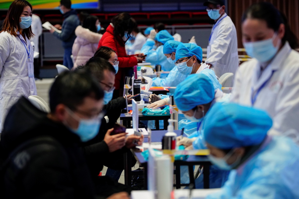 People fill forms before receiving a dose of a coronavirus disease (Covid-19) vaccine at a vaccination site in Shanghai, China January 19, 2021. u00e2u20acu201d Reuters pic