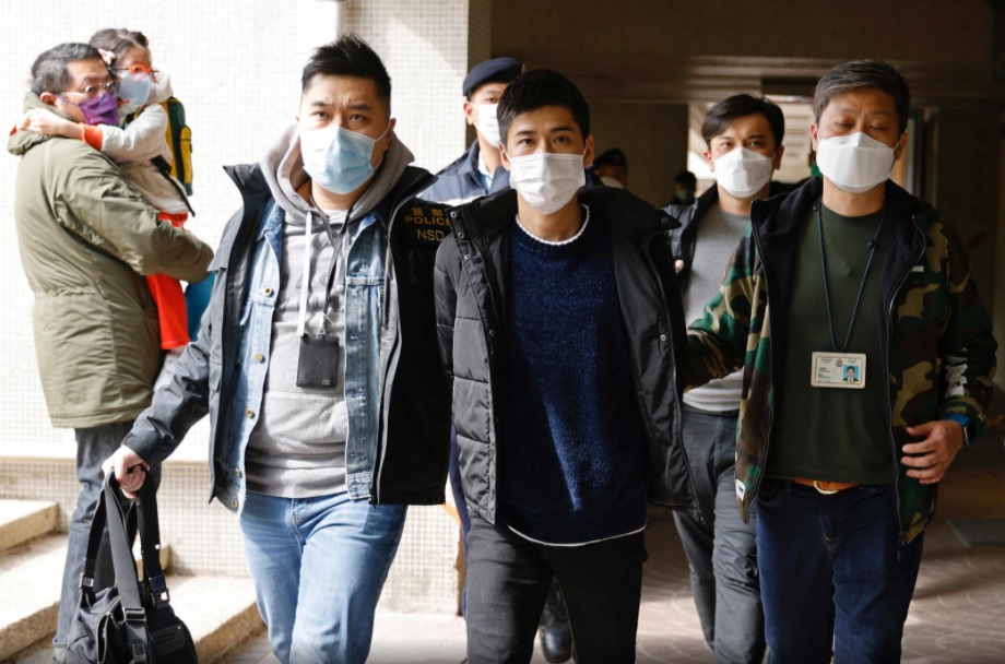 Pro-democracy activist Lester Shum is taken away by police officers after over 50 Hong Kong activists arrested under security law as crackdown intensifies, in Hong Kong, China January 6, 2021. REUTERS/Tyrone Siu