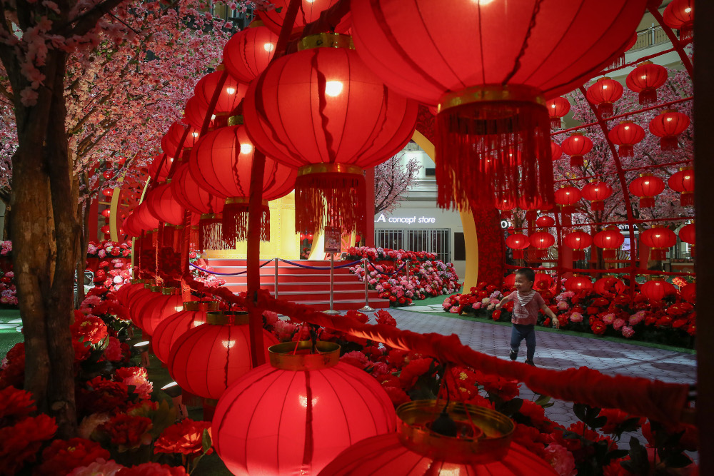 A boy runs across the floor of the mall decorated with lanterns ahead of the Lunar New Year celebrations at Suria KLCC mall in Kuala Lumpur January 21, 2021. u00e2u20acu201d Picture by Yusof Mat Isa