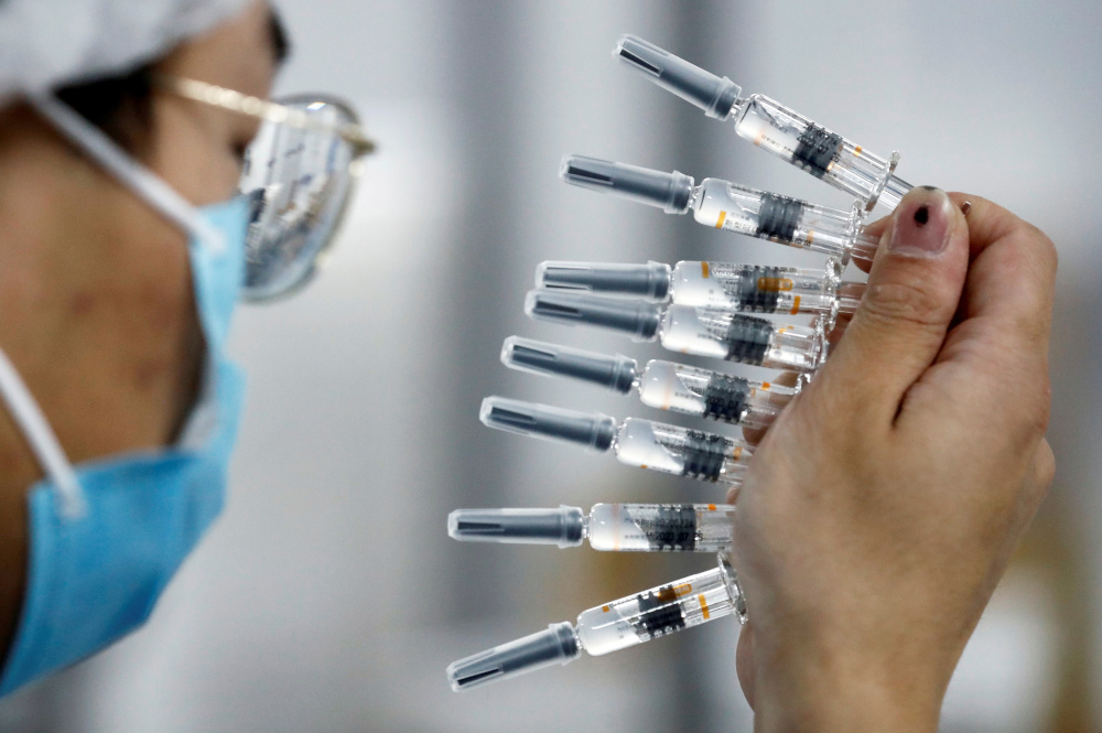 A worker performs a quality check in the packaging facility of Chinese vaccine maker Sinovac Biotech, developing an experimental coronavirus disease vaccine, during a government-organised media tour in Beijing, China, September 24, 2020. u00e2u20acu201d Reuters picnn