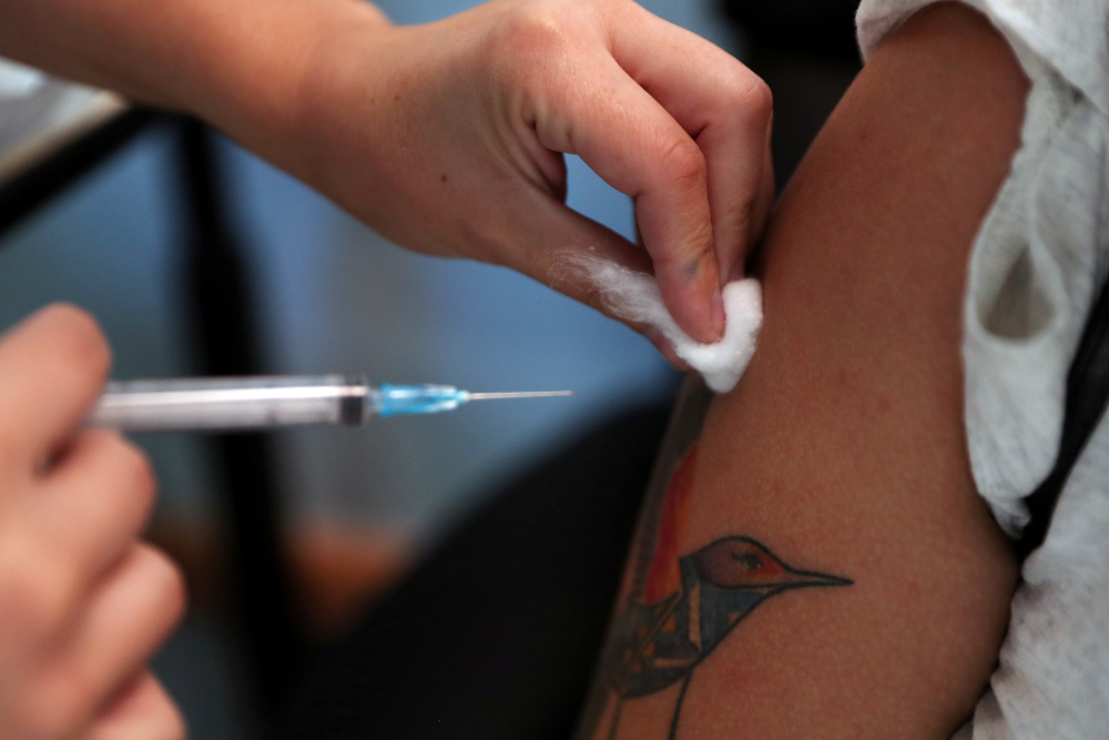 A healthcare worker receives a second dose of Pfizer/BioNTech vaccine against the coronavirus disease at the Posta Central hospital in Santiago, Chile January 14, 2021. u00e2u20acu201d Reuters picn