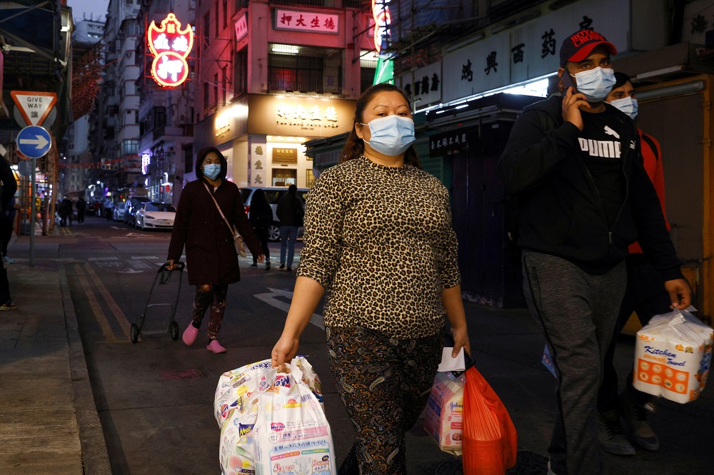 Residents wear face masks as they walk at Jordan residential area, where tens of thousands of its residents will be placed in a lockdown to contain a new outbreak of the coronavirus disease in Hong Kong January 22, 2021. u00e2u20acu2022 Reuters pic