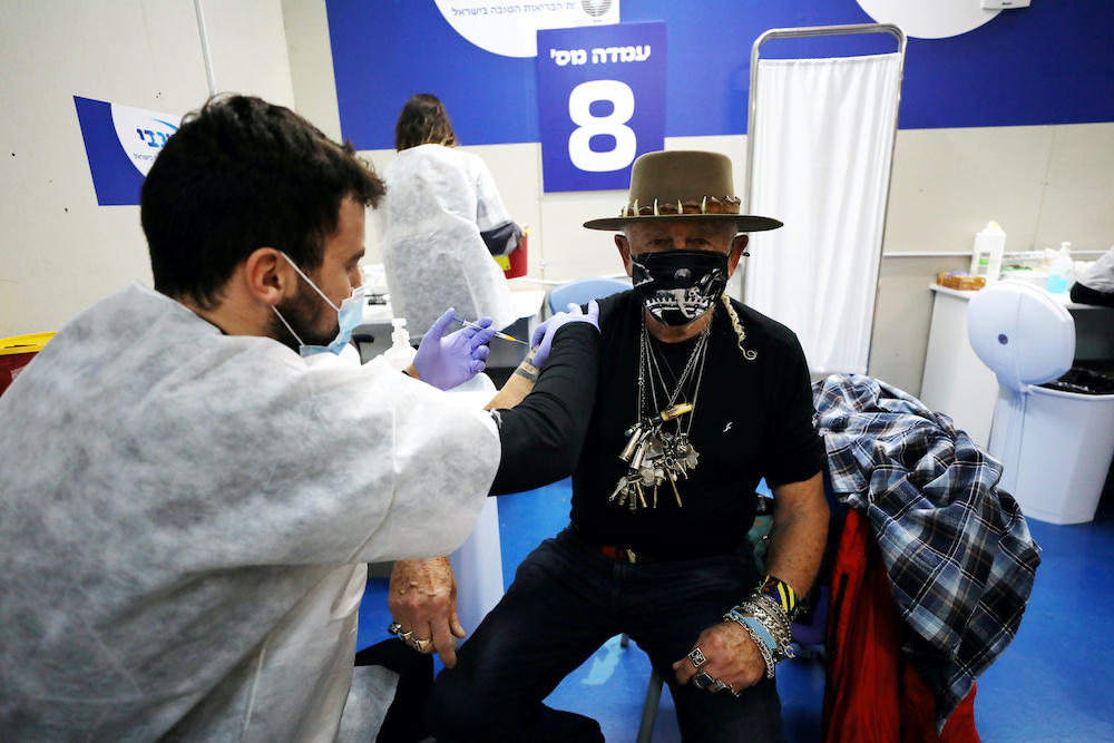 A man receives a vaccination against the coronavirus disease at a temporary healthcare maintenance organisation centre in Givatayim Mall, near Tel Aviv, Israel January 19, 2021. u00e2u20acu201d Reuters picnnn